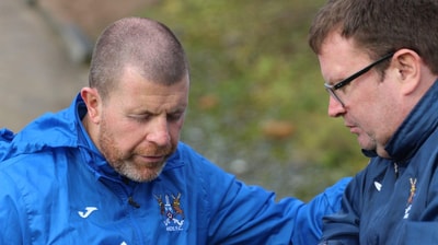 Chaplain praying with a mnager