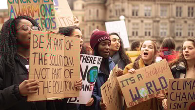 Climate protesters with cardboard signs