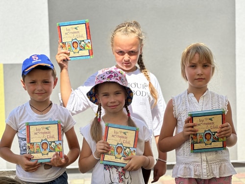 Children receiving Bible storybook