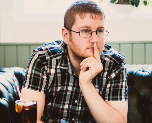 Man sitting with notepad and pen