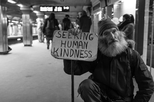 Man With Sign Asking For Human Kindness