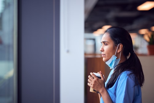 Nurse gazing through a window