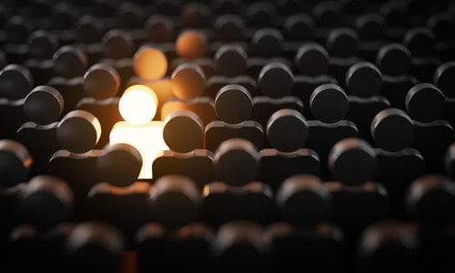 One Man Glowing Among Other People in Dark Condition