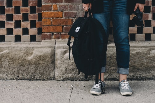 Teenager Standing Near A Brick Wall