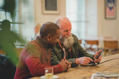Two men looking at phone