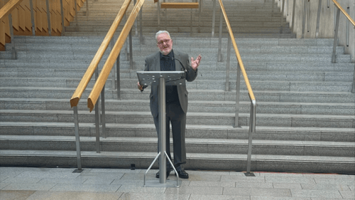 Fred Drummond presenting at Holyrood, Parliament