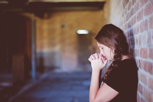 Woman praying in chapel