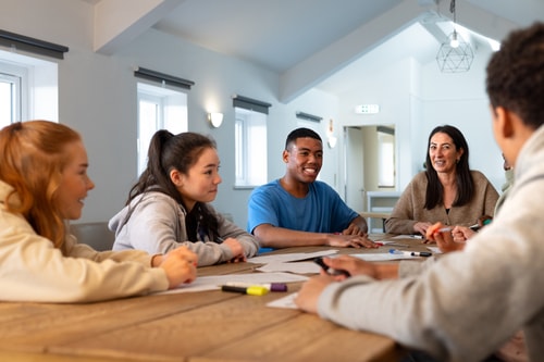 young people talking at table