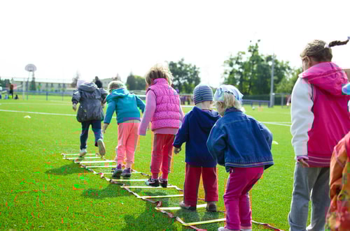 Children on green grassland playing a game