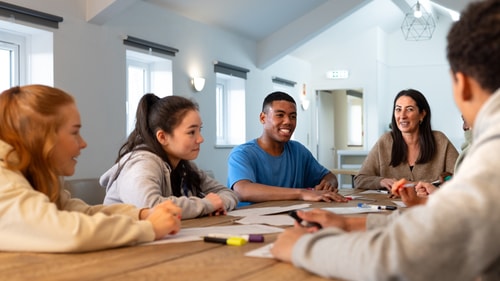 young people talking at table