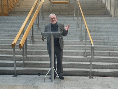 Fred Drummond presenting at Holyrood, Parliament